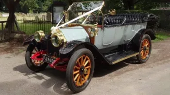 Left Side view of Convertible Oakland decorated with wedding ribbons, wooden spoke wheels