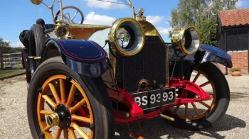 Close up front view of Oakland wedding car showing the wooden spokes wheels and gold brasse front radiator green and light
