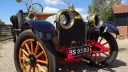 Close up front view of Oakland wedding car showing the wooden spokes wheels and gold brasse front radiator green and light