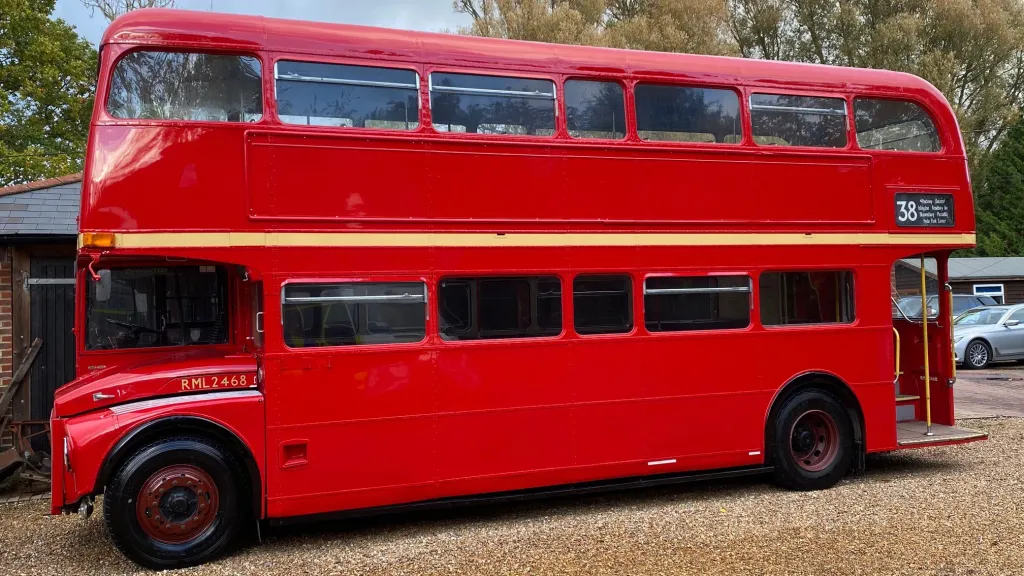 Side view of Double Decker Red Routemaster London Bus with rear open platform
