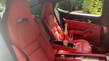 Rear interior with burgundy sports seats showing and middle armrest