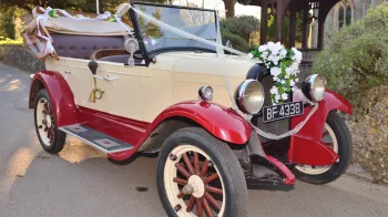 Right front view of Chevrolet Capitol AA Convertible with open roof in fron of Church