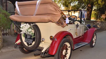 Rear view of the vintage Chevrolet Convetible with roof down in front of Church.