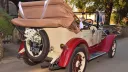 Rear view of the vintage Chevrolet Convetible with roof down in front of Church.