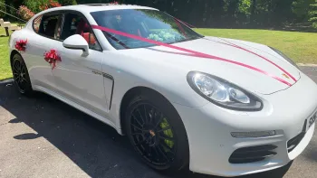 Side View Porsche Panamera with V-shaped Red Ribbons on bonnet