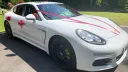 Side View Porsche Panamera with V-shaped Red Ribbons on bonnet