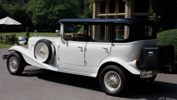 Rear view of vintage Beauford with black picnic trunk attached at the rear of the vehicle