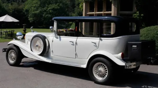 Rear view of vintage Beauford with black picnic trunk attached at the rear of the vehicle