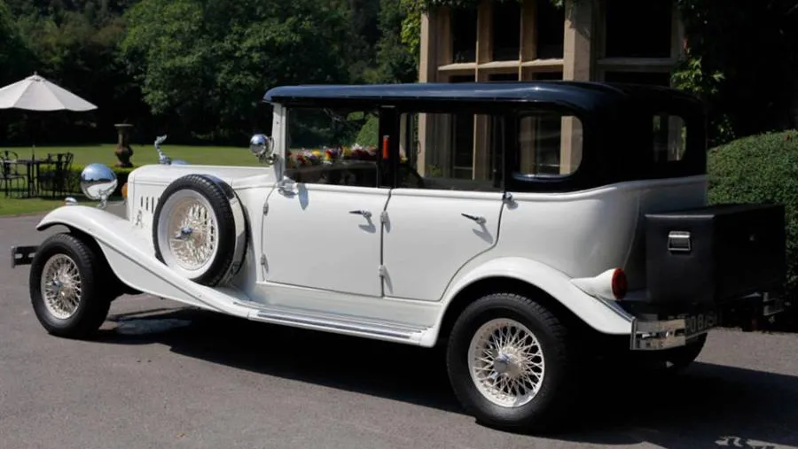 Rear view of vintage Beauford with black picnic trunk attached at the rear of the vehicle