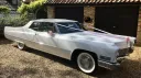 Cadillac Convertible in White w-ith white wall tires and convertible roof closed up