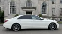 Right side view of White Mercedes decorated with white ribbons and large chrome alloy wheels