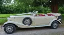 Beauford Convertible with convertible roof open showing burgundy leather interior