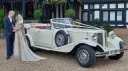 Beauford Convertible with Bride and Groom standing by the vehicle