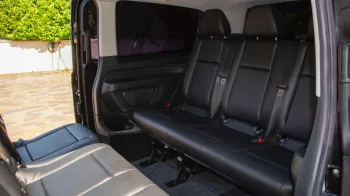 Rear interior seating in Mercedes V-class with Black Leather interior facing each others.