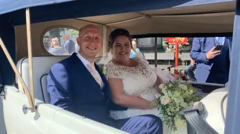 Bride and Groom seating inside vintage Beauford