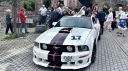 Ford Mustang GT V8 front view with wedding guests in the background