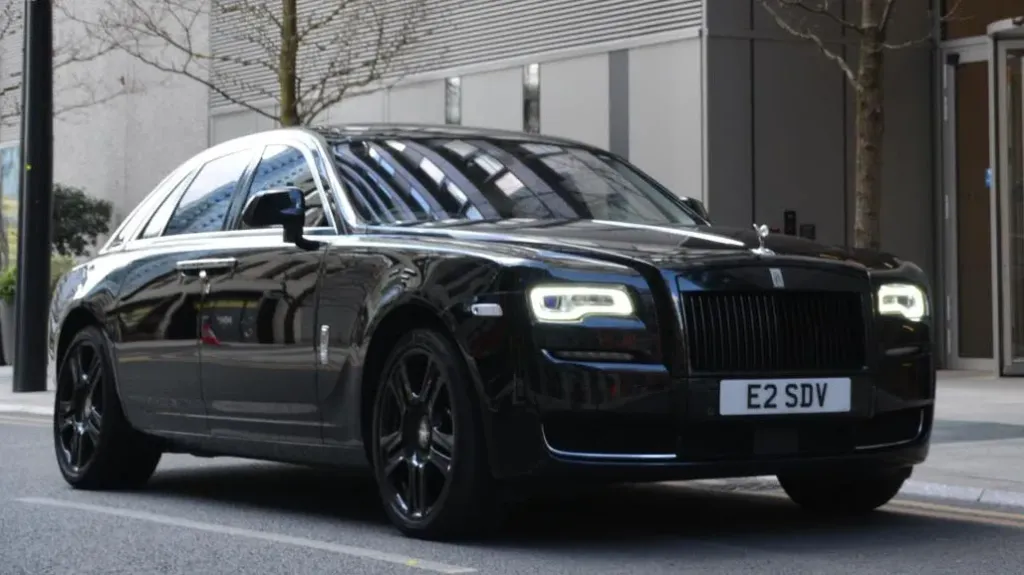 Rolls-Royce Ghost Series II in Black parked in front of a wedding venue