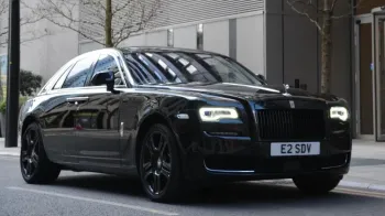 Rolls-Royce Ghost Series II in Black parked in front of a wedding venue