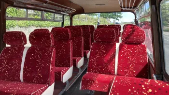 Red interior seats inside a Classic Bedford Bus