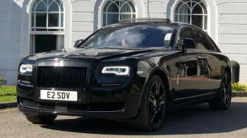 Black Rolls-Royce Ghost Series II with black alloy wheels parked in front of wedding venue in Hertfordshire
