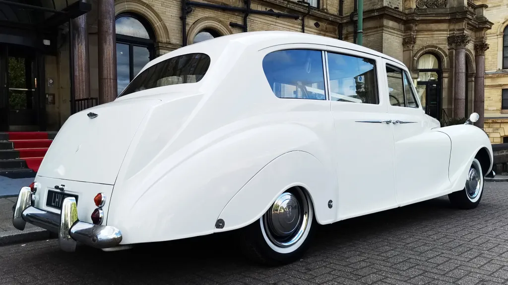 Rear right view of classic Austin car in front of registrar office