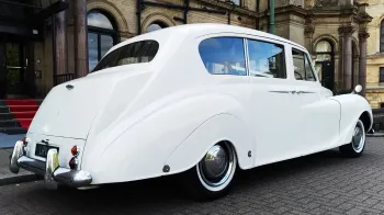 Rear right view of classic Austin car in front of registrar office
