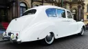 Rear right view of classic Austin car in front of registrar office