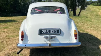 Full rear view of Classic Rolls-Royce with chrome rear bumper