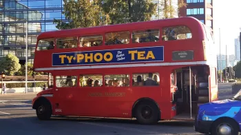 Routemaster bus traveklling in street of london with Wedding guests inside