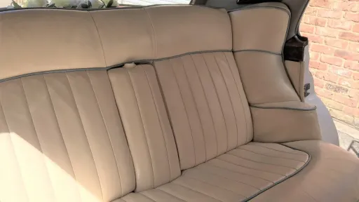 Cream leather interior of the rear bench seat in classic rolls-royce silver cloud