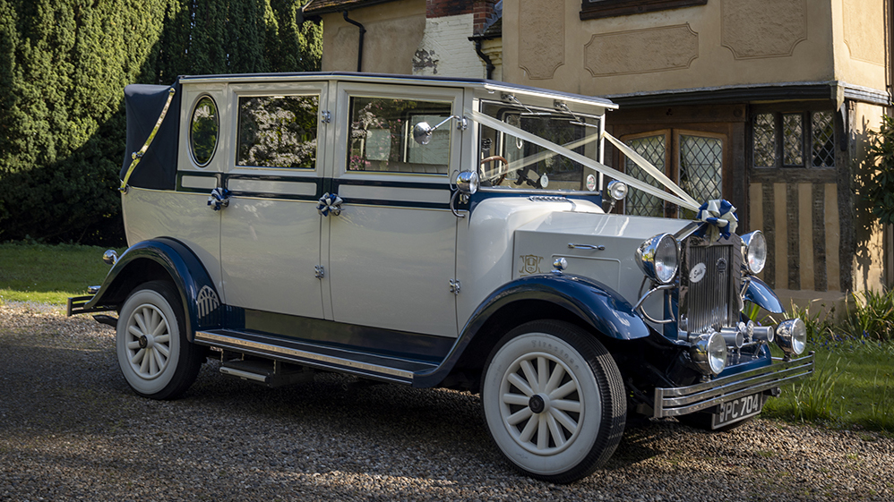 vintage wedding car in Blue and ivory with wedding ribbons