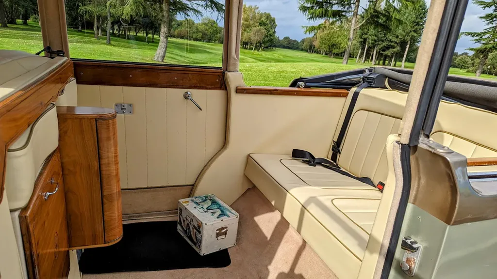 Regent Landaulette interior cream leather interior with light varnished wood panels on top of the door
