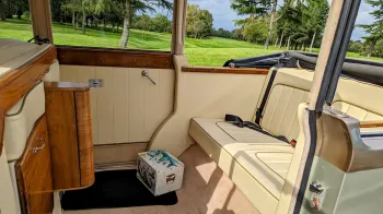 Regent Landaulette interior cream leather interior with light varnished wood panels on top of the door