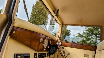 Regent Landaulette front passenger and driver space, cream leather and wooden dashboard.