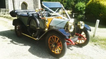 Vintage Oakland Model 40 Convertible decorated with White Ribbons in front of a church