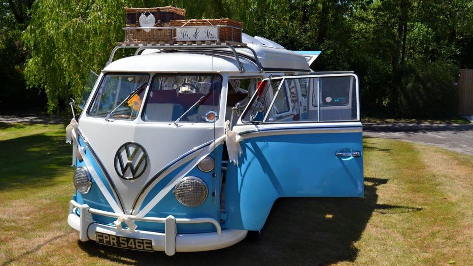 Classic VW campervan in Blue and White with retro decoration on top