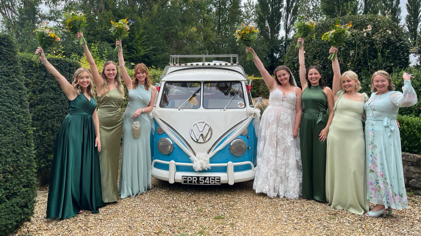 Classic VW campervan in the middle of Bride and her Bridesmaids wearing different shade of green dresses